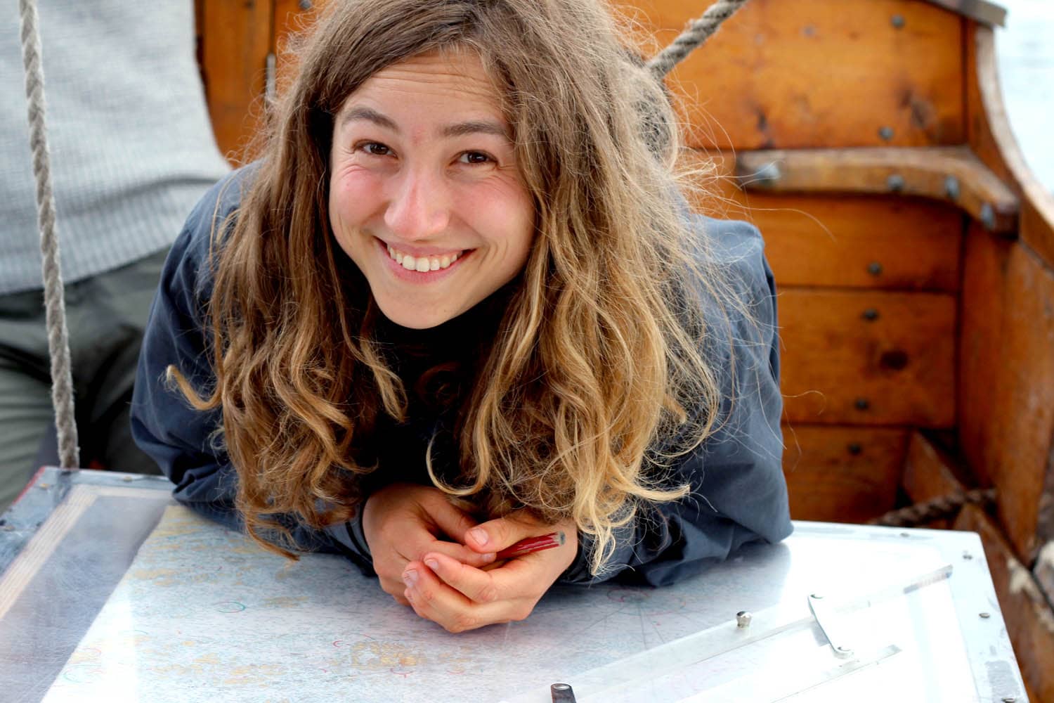 Happy sailor girl navigating with a paper map